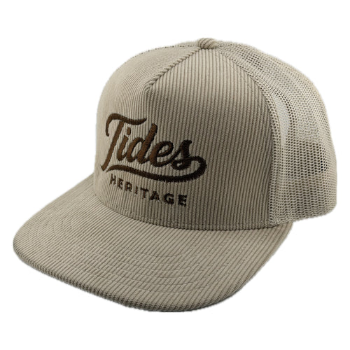 A beige corduroy trucker hat with a dark brown embroidered 'Tides Heritage' logo on the front, set against a plain white background. Tides Heritage Hat 

