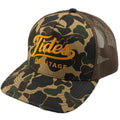 A trucker-style cap featuring a green and brown camouflage pattern on the front panel and brim, with a dark brown mesh back. The front is embroidered with 'Tides HERITAGE' in yellow-gold thread.  THE BRAND IS TIDES HERITAGE AND FEATURES A DUCK CAMO.  